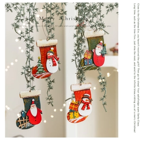 Close-up of painted wooden Christmas stockings featuring Santa and snowman patterns