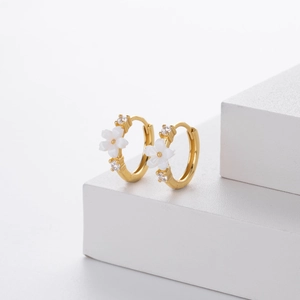 Close-up of S925 silver gold hoop earrings with white flower charms and zircon stones