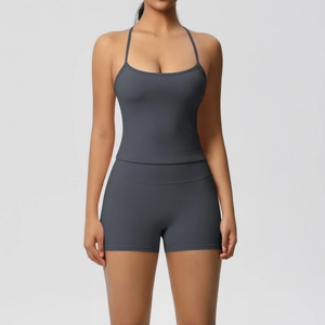 Detail of grey two-piece yoga set featuring thin strap tank top and high waist shorts