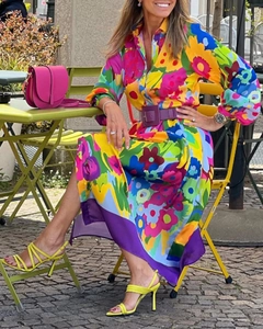 Detail of vibrant floral midi dress with purple waist belt and colorful floral print