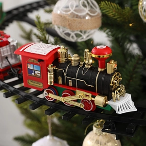 Electric Christmas train toy with vintage steam engine on tracks around a festive tree