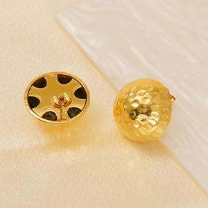 Detailed view showing hammered texture and inner structure of 18K gold titanium earrings