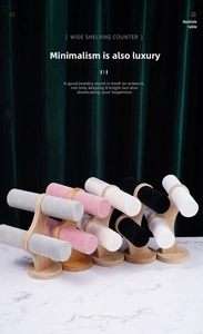 Bamboo and velvet T-bar jewelry display stands in five colors on marble surface