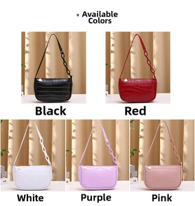 Detail view of crocodile pattern hobo bags in black red white purple and pink