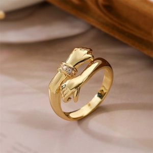Macro shot of gold hug ring with micro-pave cubic zirconia on hands detail