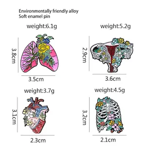 Floral anatomy enamel pin set featuring pink lungs, uterus, heart, and rib cage designs