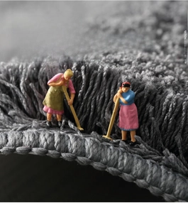 Macro shot of gray microfiber bath mat showing dense fibers and reinforced edge durability