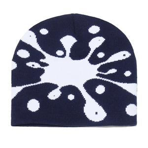 Detail of the high-quality dark blue knitted beanie featuring a white ink splash pattern