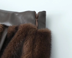Macro view of brown faux fur and leather texture with concealed zipper on the skirt