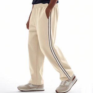 Detailed side view of beige jogger pants with black side stripes and soft knit fabric