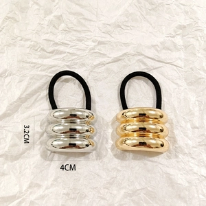 Detail view of gold and silver hollow metal hair rings showing dimensions 4cm by 3.2cm
