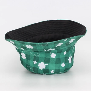 Close-up detail of the white shamrock print on a green checkered outdoor bucket hat