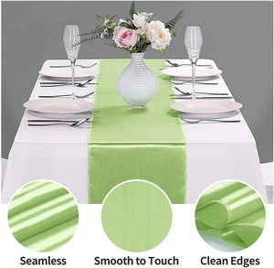 Macro detail of smooth light green satin table runner with seamless edges and glossy finish