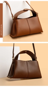 Close-up of brown litchi pattern leather texture and gold hardware on square tote bag