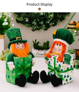 Detail of St. Patrick's Day leprechaun plush dolls sitting on green clover gift boxes