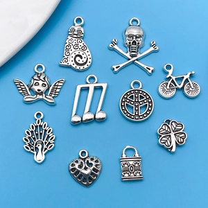 Detailed view of mixed silver alloy charms featuring skulls, cats, and musical notes