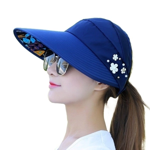 Women's dark blue wide-brim sun hat with floral leaf lining and pearl flower detail