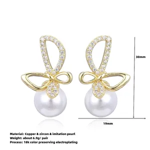 Elegant 18K gold butterfly bow earrings with white pearls and zircons on white background