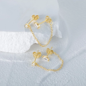 Macro shot of S925 sterling silver stamp on gold chain tassel eye stud earrings