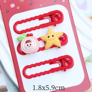 Detail of red festive clips with cute cartoon star and cake on decorative card 1.8x5.9cm