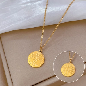 Detail of gold titanium steel necklace with Fu and Xi Chinese characters on round pendant