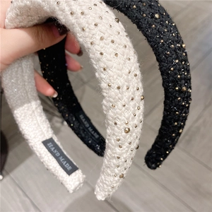 Three padded tweed headbands with gold rivets and hand made label on wooden floor