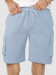 Detail of light blue cargo shorts featuring drawstring waist and large side pockets
