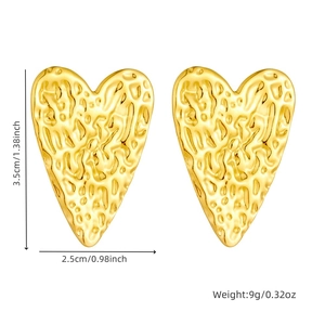 Detailed view of gold heart earrings with hammered texture and dimensions 3.5cm by 2.5cm