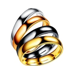 Detailed close-up of four-color stainless steel minimalist rings in a stacked arrangement