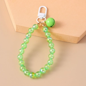 Detail of green transparent beaded keychain featuring a spring clasp and matching bell charm