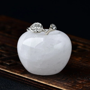 Macro view of crystal apple decor with rhinestone metal leaf on a wooden base