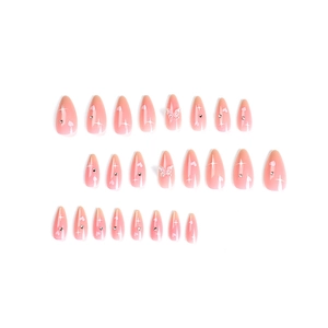Pink almond press-on nails with white hearts, rhinestones, and 3D butterfly charms