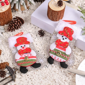 Christmas stockings with plush snowman and bear dolls on a snowy decorative background