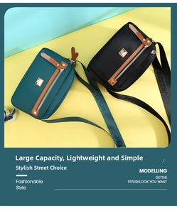 Detail of waterproof nylon crossbody bags with dual zipper pockets and leather trim