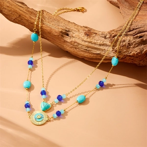 Bohemian gold chain necklace with turquoise beads and sun-shaped geometric pendants