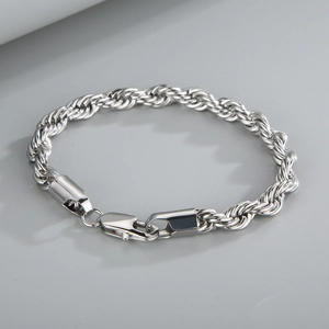 Detailed view of silver twist chain bracelet with polished finish and secure lobster clasp