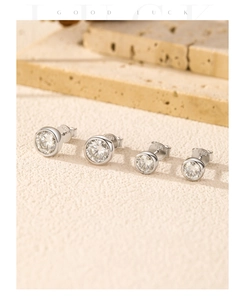 Detail of round moissanite stud earrings featuring S925 sterling silver engraved hallmark