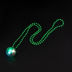 Glow-in-the-dark disco ball pendant with green bead chain on a dark background