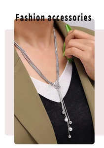 Detail of silver multi-layer tassel necklace with white pearl pendants and OT clasp