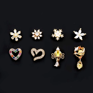 Detailed grid of gold heart and star studs with cubic zirconia on black background