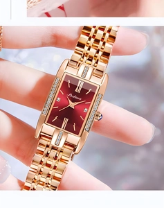 Detailed close-up of rose gold square watch with red sunray dial and diamond accents