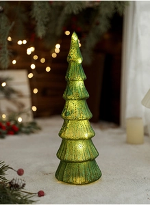 Close-up of mercury glass Christmas tree with glowing LED light and mottled texture