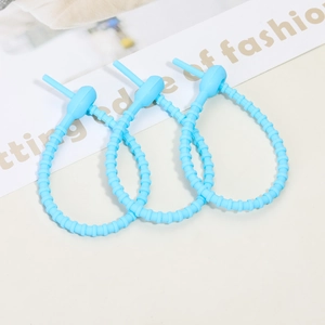 Three light blue silicone cable ties in a closed loop showing textured ribbing details