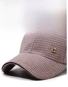 Detail of pink houndstooth plaid baseball cap with crystal gold metal buckle accent