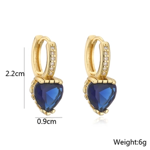 Macro detail of 18K gold plated heart earrings with blue stone measuring 2.2x0.9cm