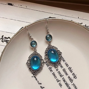 Vintage ethnic oval blue resin drop earrings with intricate silver floral lace borders