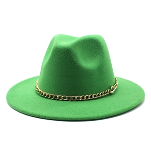 Detail of green wool fedora hat featuring wide flat brim and decorative gold chain