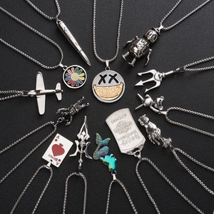 Macro detail of alloy pendant necklaces featuring silver heart and trendy metal charms