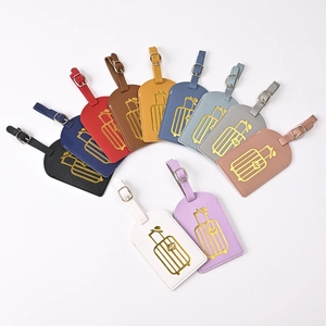 Close-up of premium PU leather luggage tags with gold foil suitcase motifs in various colors