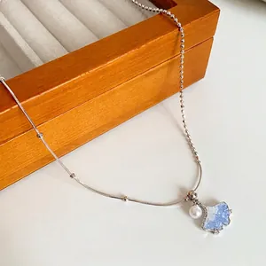 Silver ginkgo leaf butterfly necklace with blue zircon crystal and white pearl accent